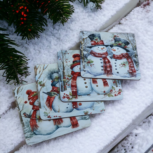 set of 4 coasters featuring pairs of holiday snowmen