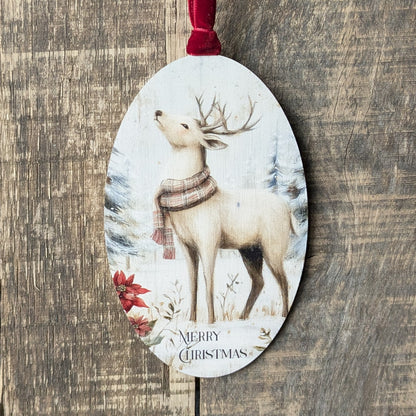 Decorative Christmas ornament with a deer wearing a scarf on a wooden surface
