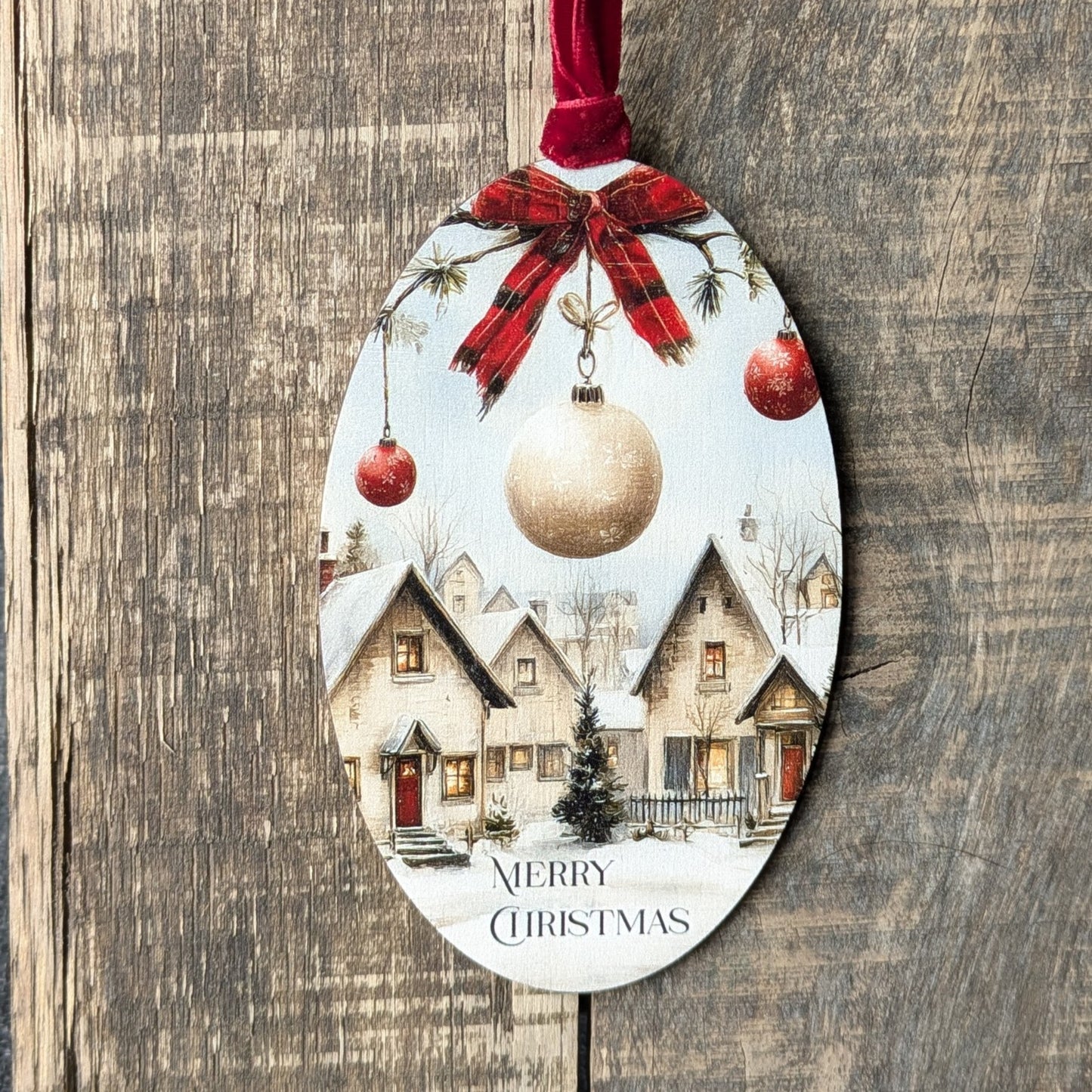 Decorative Christmas ornament with a village scene and ornaments on a wooden background