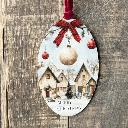 Decorative Christmas ornament with a village scene and ornaments on a wooden background