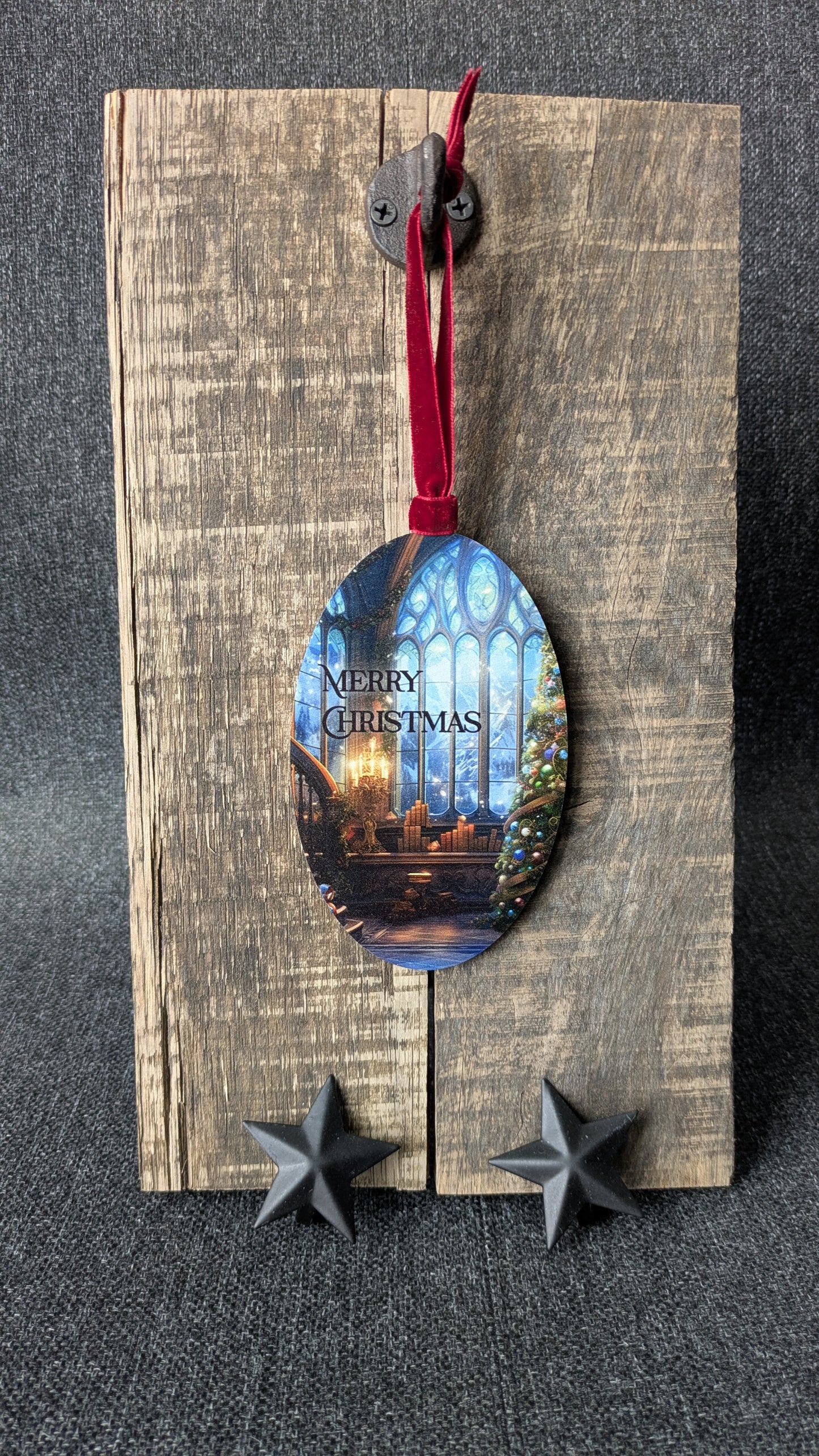 Decorative wooden ornament with a Christmas scene on a gray background
