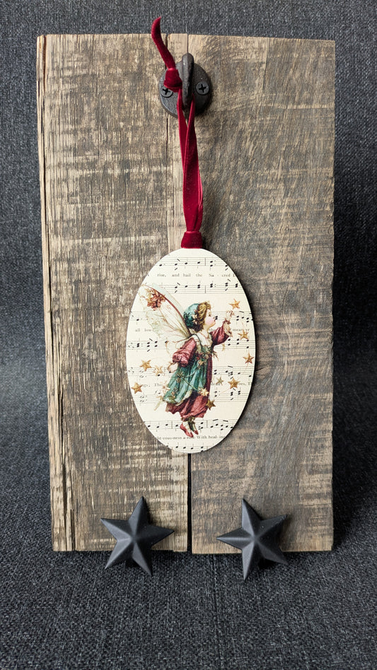 Decorative angel ornament on a wooden board with stars below