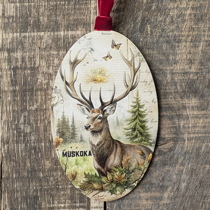 Decorative ornament with a deer design and 'Muskoka' text on a wooden background