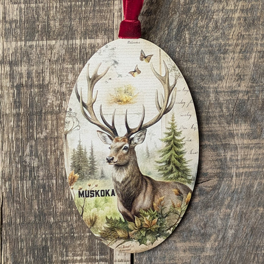 Decorative ornament with a deer design and 'Muskoka' text on a wooden background