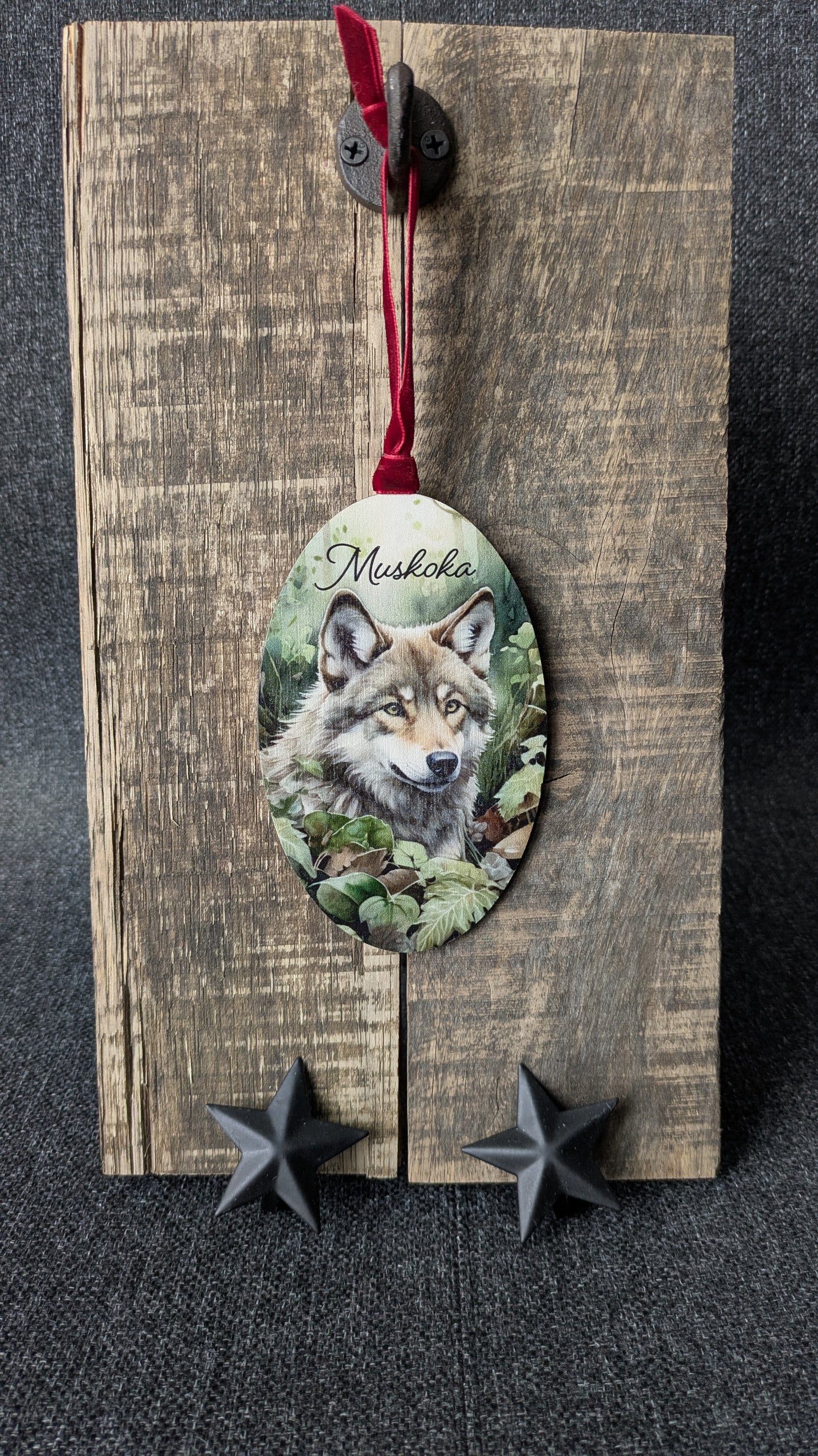 Decorative wooden ornament with a wolf illustration and 'Musikka' text on a dark background